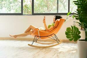 image of asian girl relaxing on a chair at her house photo