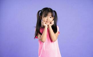 beautiful asian girl portrait posing on purple background photo