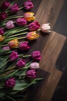 Vibrant Tulips Against Dark Wooden Background photo