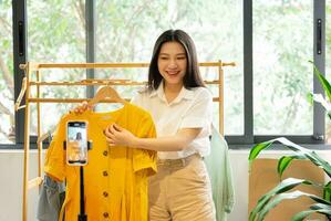 portrait of asian woman selling online at home photo