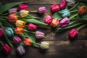 Vibrant Tulips Against Dark Wooden Background photo