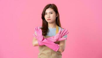 portrait of asian girl wearing apron on pink background photo