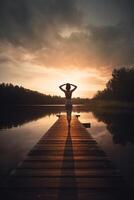 Serenity in Motion Woman Engaging in Sunset Yoga on Lake Pier photo