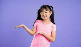 beautiful asian girl portrait posing on purple background photo