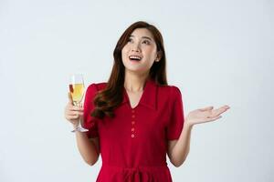 Portrait of a beautiful, charming lady wearing a red dress on a white background photo