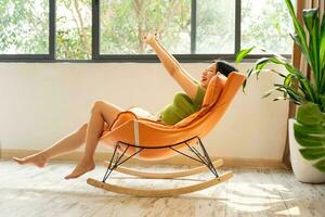 image of asian girl relaxing on a chair at her house photo