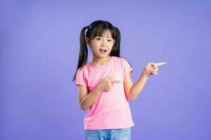 beautiful asian girl portrait posing on purple background photo