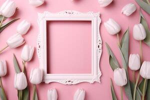 Empty white picture frame with pink tulips on a pink background photo