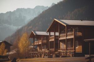 Panoramic view of a hostel in the mountains surrounded by lush green landscape photo