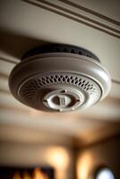 Ceiling-mounted smoke detector in a residential building photo