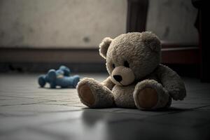 Sad lonely teddy bear lying on the floor symbol of abuse victims photo