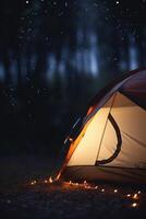 Camping in the Dark Illuminated Tent in the Forest photo