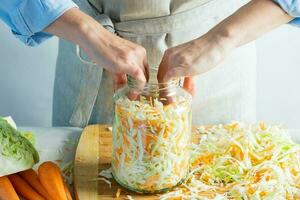 The preparation process fermentation preservation Sauerkraut on a light background. Natural rustic style. Canned food photo