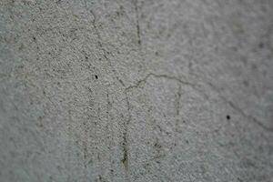 Cracked concrete wall surface, solid soil wall background, cement backdrop photo