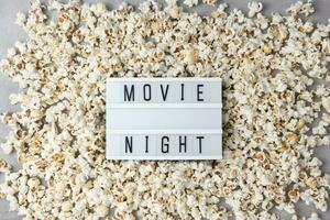 Text MOVIE NIGHT with popcorn. Movie theater and cinema snacks photo