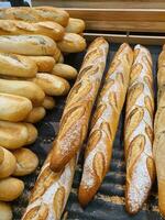 Different types of French baguettes in a bakery photo