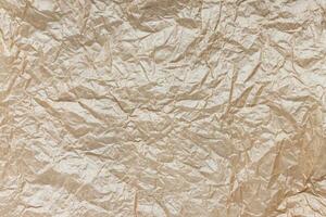 Crumpled brown kraft paper texture background photo