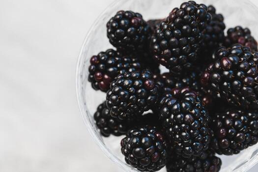 Fresco moras en un estampado vaso cuenco en gris antecedentes foto