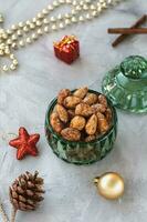 Candied or sugared almond in glass jar on Christmas background. Still Life photo
