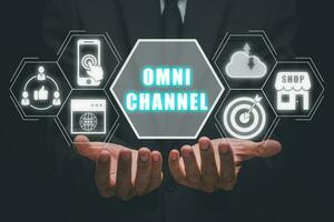 Omni channel concept, Person hand holding omni channel icon on virtual screen. photo