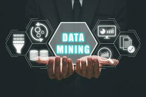 Data mining for business and organization, Businessman hand holding data mining icon on VR screen, internet and networking concept. photo