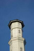 Purwakarta, 05 May 2023 - View of the minaret of the Tajug Gede Cilodong Mosque against a blue sky as a background, located in Cilodong, Purwakarta photo