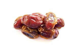 Pile of tasty dry dates isolated on white background. Kurma, buah kurma, Arabic food. photo