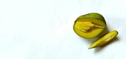 Slice of fresh mango with green skin color on white background. with copy space. photo