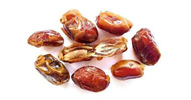 Pile of tasty dry dates isolated on white background. Kurma, buah kurma, Arabic food. photo