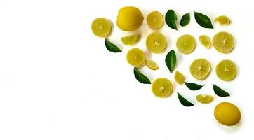 Fresh yellow lemon slice on a white background with green leaves, copy space concept. photo