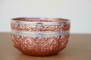 Thai traditional copper silver bowl. Buddhists use this bowl to temple or do ceremony, ritual that involves  Buddhism and use in Thai Songkran festival  as water bowl. Handicrafts style of Thailand photo