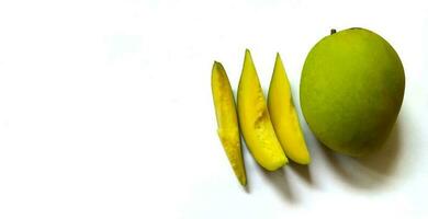 Slice of fresh mango with green skin color on white background with copy space. photo