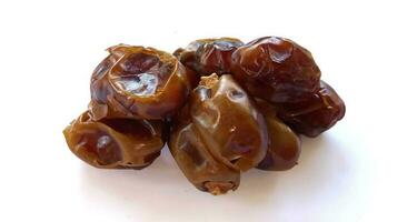 Pile of tasty dry dates isolated on white background. Kurma, buah kurma, Arabic food. photo