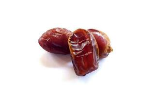 Pile of tasty dry dates isolated on white background. Kurma, buah kurma, Arabic food. photo