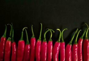 Fresh red chili on a black background as a background. photo