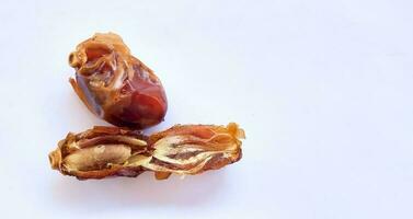 Pile of tasty dry dates isolated on white background. Kurma, buah kurma, Arabic food. photo
