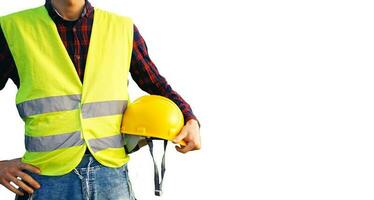 Construction worker holding yellow helmet. Building worker wearing fluorescent waistcoat. Isolated. photo