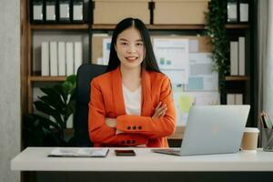 Business woman using tablet and laptop for doing math finance on an office desk, tax, report, accounting, statistics, and analytical research concept photo