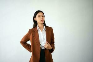 Portrait photo of young beautiful Asian woman feeling happy and holding smart phone, tablet and laptop with black empty screen on white background product presenting concept.