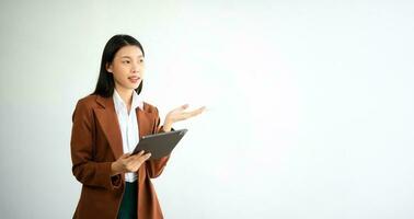 Portrait photo of young beautiful Asian woman feeling happy and holding smart phone, tablet and laptop with black empty screen on white background product presenting concept.