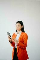 Portrait photo of young beautiful Asian woman feeling happy and holding smart phone, tablet and laptop with black empty screen on white background product presenting concept.