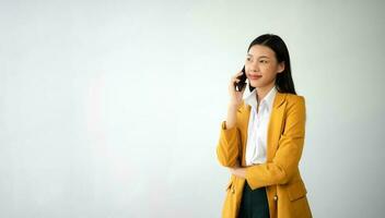 Portrait photo of young beautiful Asian woman feeling happy and holding smart phone, tablet and laptop with black empty screen on white background product presenting concept.