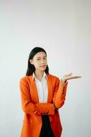 Portrait photo of young beautiful Asian woman feeling happy and holding smart phone, tablet and laptop with black empty screen on white background product presenting concept.