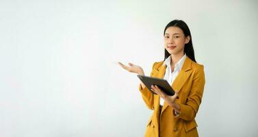 Portrait photo of young beautiful Asian woman feeling happy and holding smart phone, tablet and laptop with black empty screen on white background product presenting concept.