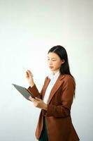 Portrait photo of young beautiful Asian woman feeling happy and holding smart phone, tablet and laptop with black empty screen on white background product presenting concept.