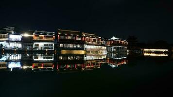 The old Chinese town night view with the lights on as background photo