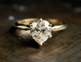 Gold ring with diamond in the shape of drop with reflection photo