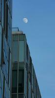 The blue sky view with the curve white moon in the sky in the day photo