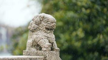 The old stone lion sculpture view along the old arched stone bridge in the old little town of the China photo