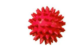 Red rubber ball with spikes on a white background. photo